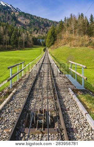 Trees And Railway On The Foot Of Mt. Stanserhorn In Switzerland In The Beginning Of May. Mt. Stanser
