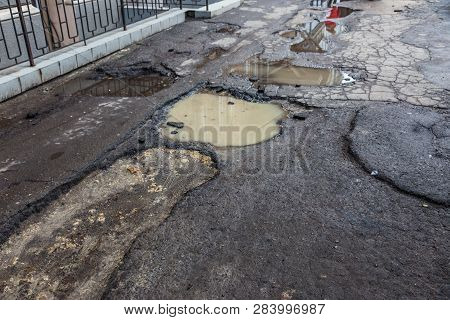 Very Bad Quality Road With Potholes. Hole In Asphalt, Bad Asphalt. Pit, Unsafe, Hole Road. Transport