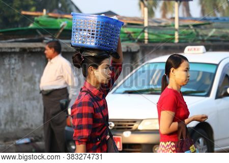 Yangon, Myanmar, Feb 24, 2019: Myanmese Woman With Thanakha (myanmar Powder) On Their Face Put The P