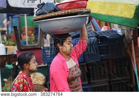 Yangon, Myanmar, Feb 24, 2019: Myanmese Woman With Thanakha (myanmar Powder) On Her Face Put Big Alu
