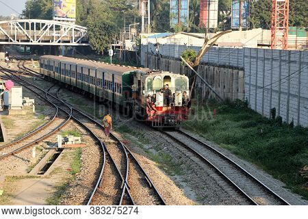 Yangon, Myanmar, Feb 20, 2019 : The Train Runs On The Railway Tracks And People Sit On The Train Loc
