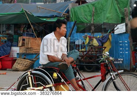 Yangon, Myanmar Feb 21, 2019:myanmarese Man Sitting On His Bicycle Tricycle Taxi For Waiting Passeng
