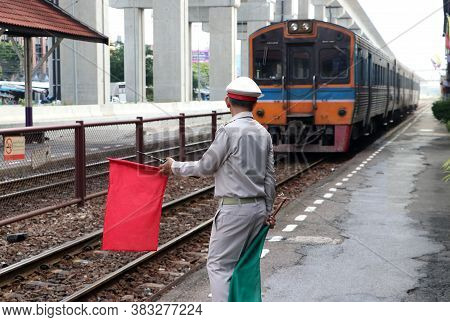 Train Officer Is Acting To Signal Safety Precautions For Passengers And People While The Train Is La