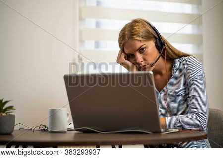 Young Modern Woman Is Working From Home. She Is Tired Of Using Computer All Day.