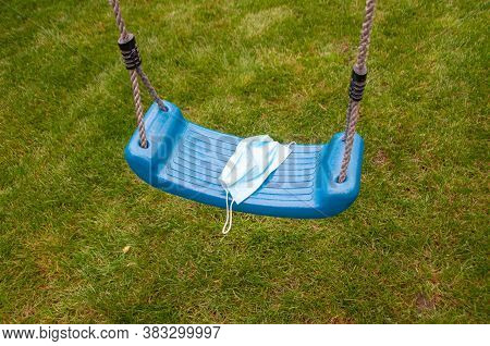 Close-up Photo Of A Protective Medical Mask On The Background In The Park. Refusal To Wear Protectiv