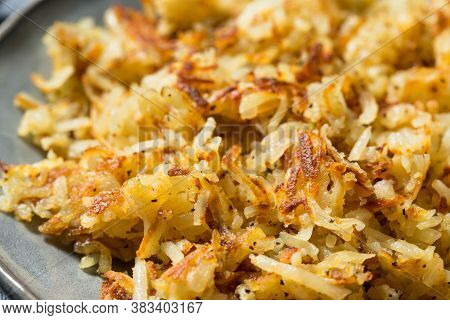 Homemade Fried Shredded Hashbrowns And Eggs For Breakfast