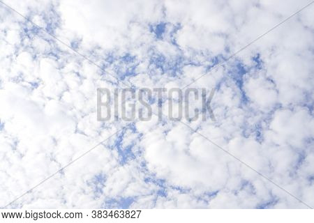 Upward View Of Beautiful White Fluffy Clouds On Vivid Blue Sky