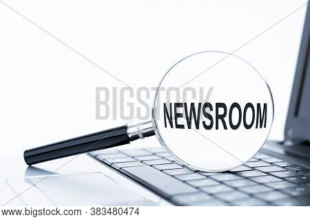 Newsroom Word On A Magnifying Glass Lying On A Laptop Keyboard