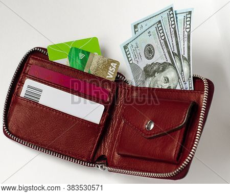 Red Wallet With Credit Cards And Dollar Bills On A White Background. Cash And Non-cash Money. Financ