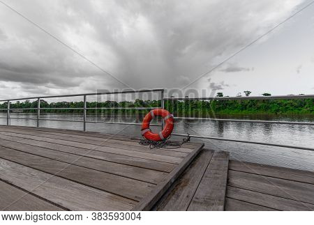 Orange Lifebuoy Ring With River Background In Brokopondo Suriname