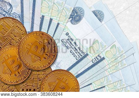 50 Sri Lankan Rupees Bills And Golden Bitcoins. Cryptocurrency Investment Concept. Crypto Mining Or 