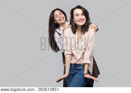 Happy Beautiful Brunette Best Friends In Casual Style Standing And Having Fun Together And And Looki