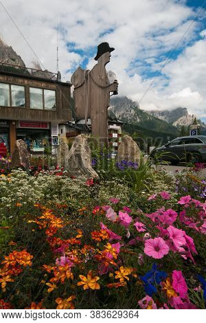 San Martino Di Castrozza, Italy - July 20, 2020: View Of Wooden Statue On The Flowers In The Histori
