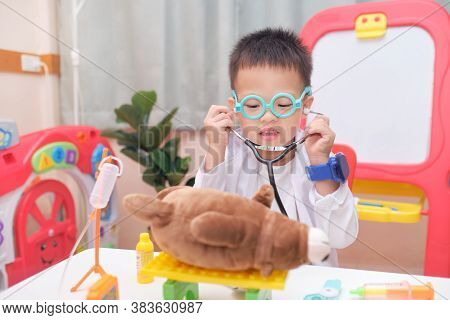 Cute Smiling Little Asian 3 - 4 Years Old Toddler Boy In Doctor Uniform Having Fun Playing Doctor Wi