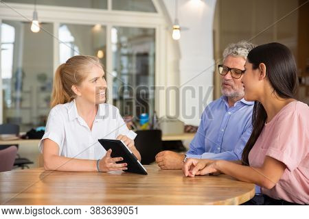 Positive Confident Female Manager Meeting With Couple Of Young And Mature Customers, Presenting Cont