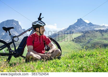 E Bike Bicycle In Austria. Man In Helmet With Mountain Ebike