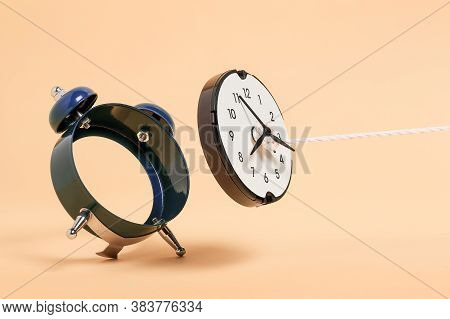 Rope Pulling Out Clock Face From Alarm Clock, Abstract Time Concept
