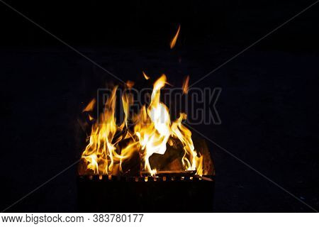 Fire On A Dark Background. Fire From Firewood Close Up. Flaming Burning Sparks Close-up, Fire Patter