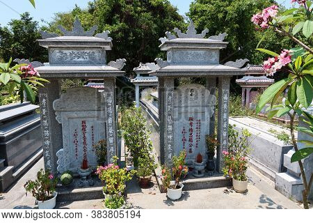 Hoi An, Vietnam, May 3, 2020: Two Graves In The Cemetery Of The Chùa Phước Lâm Temple. Hoi An, Vietn