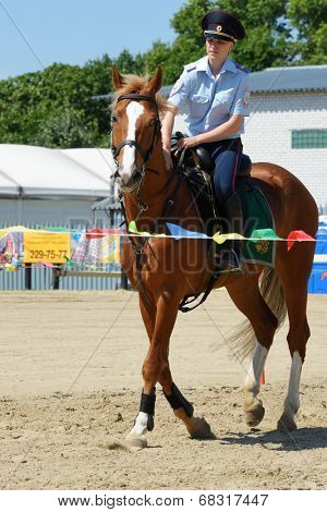 LYTKARINO, MOSCOW REGION, RUSSIA - JULY 12, 2014: Julia Lysenko of Moscow police warms up her horse during Russian championship in trick riding. Lytkarino housed the Russian Federation of trick riding