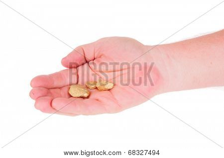 close-up of man's hand holding Gold nuggets and dust