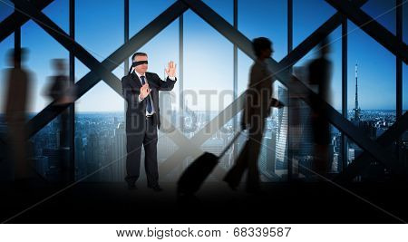 Mature businessman in a blindfold against room with large window looking on city