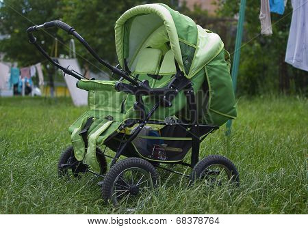 Baby Buggy On Green Grass