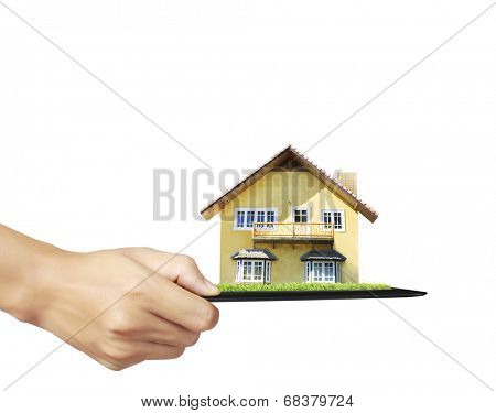 house on ,touch- tablet in a hands 