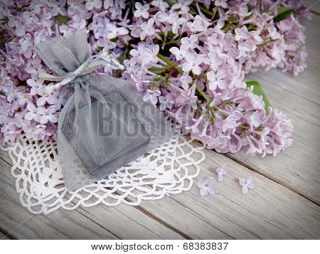 Gift And Lilac On Wood