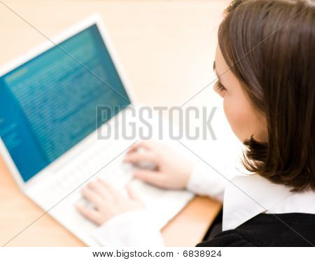 Mujer trabajando en portátil (enfoque en la mujer)