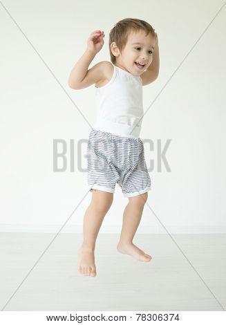 Cute little child jumping at home