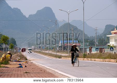 Vietnamese Riding Bicycle Alone In Border City.