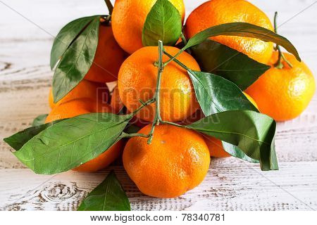 Tangerines With Leaves On A Wooden Table