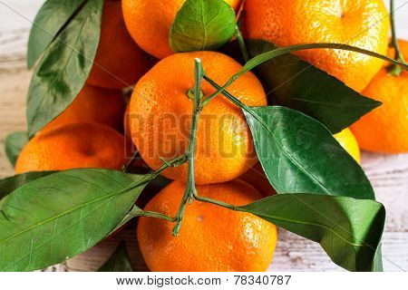Tangerines With Leaves On A Wooden Table