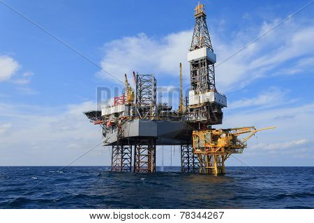 Offshore Jack Up Drilling Rig Over The Production Platform In The Middle Of The Sea
