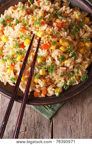 Fried Rice With Eggs, Corn And Spices And Chopsticks