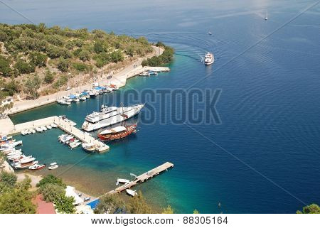 MEGANISSI, GREECE - AUGUST 31, 2008: Looking down from Spartohori onto boats moored in Spilia bay on the Greek island of Meganissi. The small Ionian island has a population of around 1100 people.