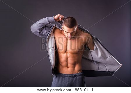 Sports guy in a tracksuit. A man in a sports jacket with a hood