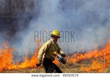 Forester Starting a Controlled Prairie Burn.
