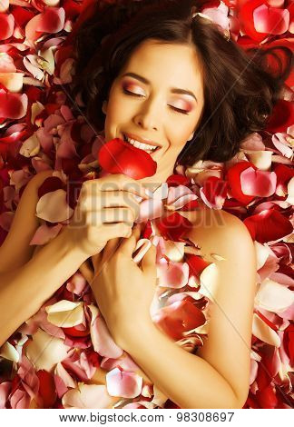beauty young brunette woman with flower close up, rose petails