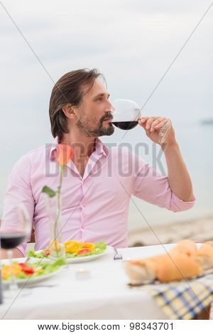 Handsome man drinking wine