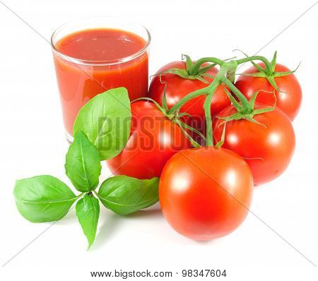 Bunch of fresh tomatoes with basil leaves and glass of tomato juice isolated on white