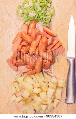 Preparing sausage and vegetables woman hands vintage tone.