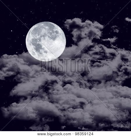 Full moon on the cloudy sky