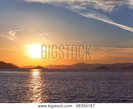 Beautiful Sunset on the sea, in the background mountains