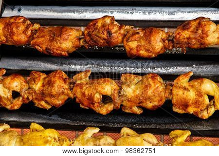 Roasted Chicken In A Row Turning At Industrial Roaster