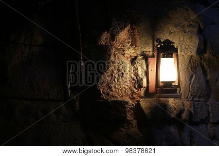 Wall lantern in a dark cave
