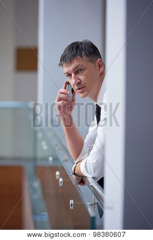 business man using phone at modern office space