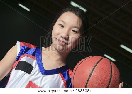 A asian basketball player in gymnase field