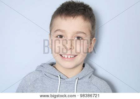 Portrait of a boy in front of a gray background